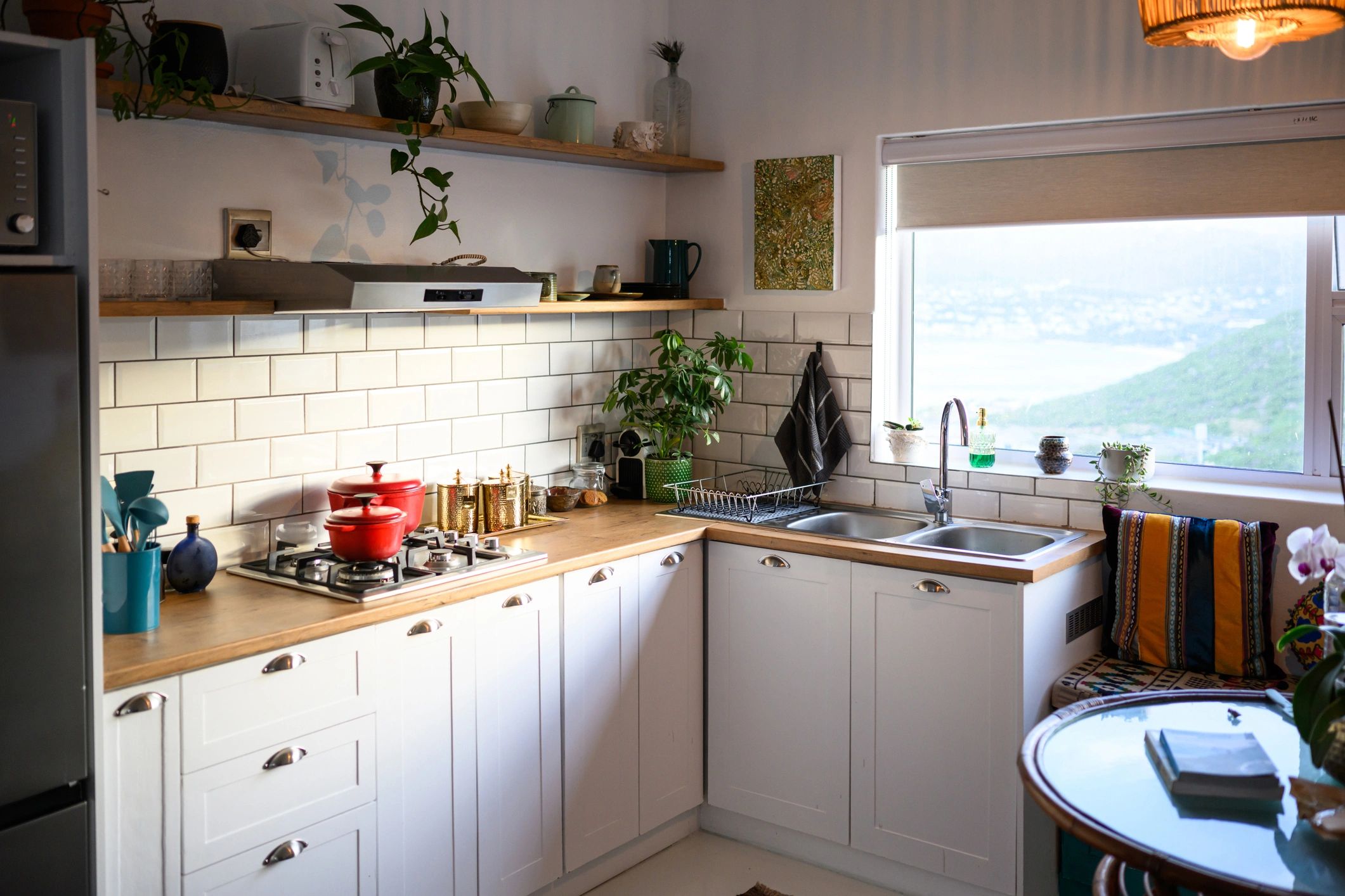 Modern kitchen remodel with white cabinets and wood shelving