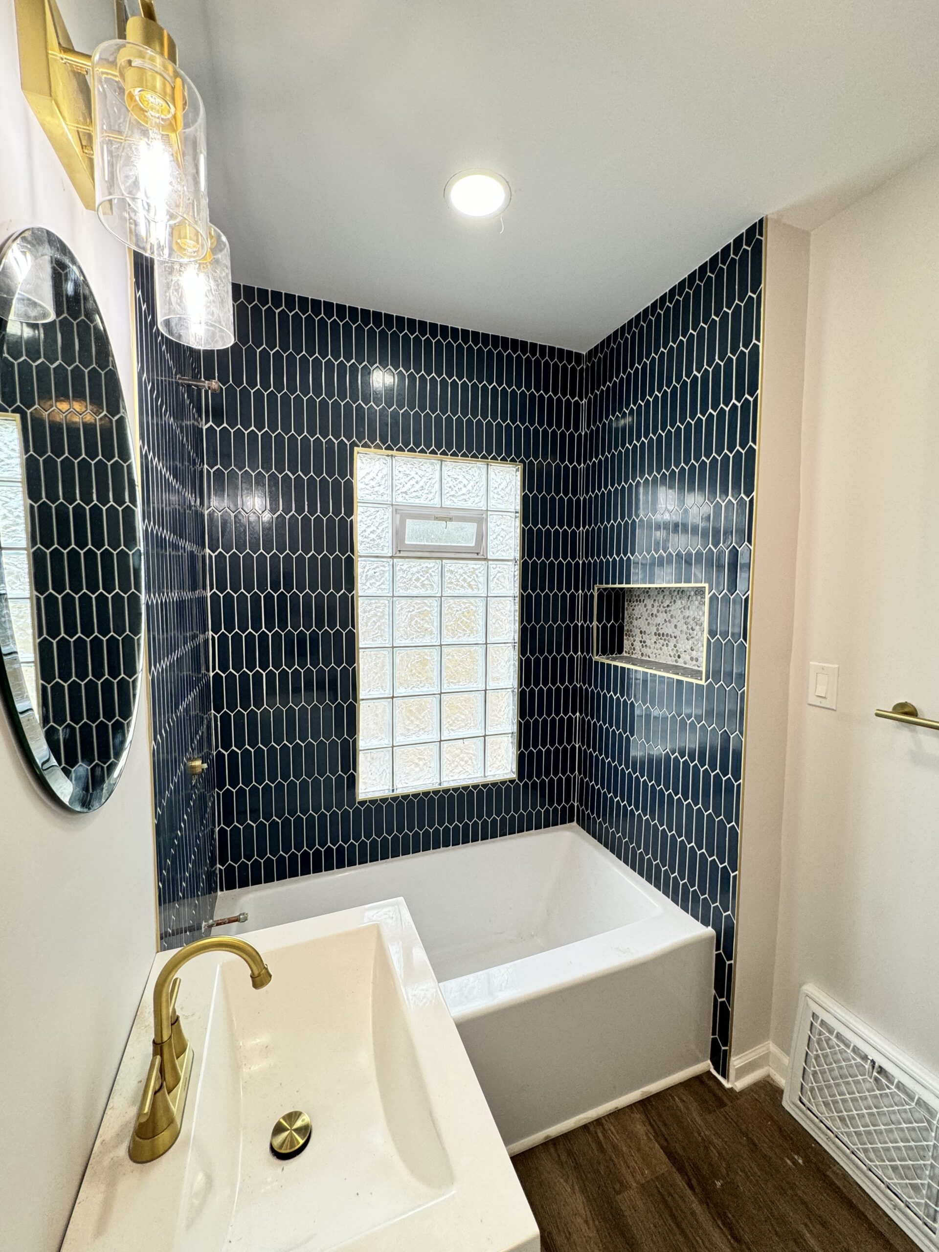 Bathroom remodel with tile, vanity, and updated fixtures
